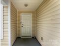 Inviting covered entryway with a light-colored front door at 6229 Sid Crane Dr, Charlotte, NC 28216