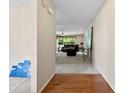 Open hallway with hardwood flooring that leads to a spacious living area with plush carpeting at 6229 Sid Crane Dr, Charlotte, NC 28216