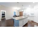 Open concept kitchen with island, granite countertops, and adjoining dining area at 679 Cape Fear St, Fort Mill, SC 29715