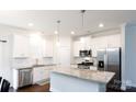 Bright kitchen with stainless steel appliances, granite countertops, and white cabinetry at 679 Cape Fear St, Fort Mill, SC 29715