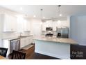 Modern kitchen featuring an island, stainless steel appliances, and sleek white cabinets at 679 Cape Fear St, Fort Mill, SC 29715
