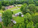 Aerial view of a home nestled amongst lush trees in a quiet neighborhood at 6900 Ridge Lane Rd, Charlotte, NC 28262