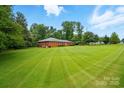 Expansive green lawn surrounds this well-maintained brick home, offering plenty of space for outdoor activities at 6900 Ridge Lane Rd, Charlotte, NC 28262