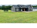 Side angle of home featuring expansive yard at 7133 Church Rd, Taylorsville, NC 28681