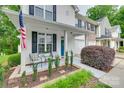 Cozy front porch with seating area and a view of the landscaped front yard at 727 Torrey Pines Ln, Fort Mill, SC 29715