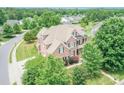 Spacious brick home surrounded by mature trees and landscaping in established neighborhood at 8409 Olde Stonegate Ln, Mint Hill, NC 28227