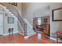 Inviting foyer with hardwood floors and staircase, leading to the living area at 8409 Olde Stonegate Ln, Mint Hill, NC 28227