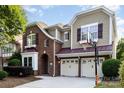 Charming two-story home featuring a two-car garage, brick facade, and meticulously landscaped front yard with basketball hoop at 9429 Ridgeforest Dr, Charlotte, NC 28277