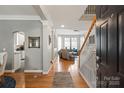 Bright entryway with hardwood floors, elegant columns, and staircase, leading into the living space at 10924 Owl Nest Ln, Charlotte, NC 28277