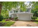 This inviting two-story home features a well-maintained lawn and an attached two-car garage at 10924 Owl Nest Ln, Charlotte, NC 28277