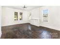Bright living room with refinished hardwood floors, ample natural light, and fresh paint at 1112 Concord Ave, Monroe, NC 28110
