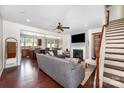 Inviting living room features a fireplace, hardwood floors, ceiling fan, and staircase at 1126 Roderick Dr, Fort Mill, SC 29708