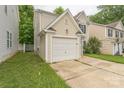 A quaint two-story home with a one-car garage and lush green lawn at 13413 Golden Apple Ct, Charlotte, NC 28215