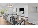 Comfortable living room with a ceiling fan, neutral tones, and access to the backyard at 1377 Beagle Run, Salisbury, NC 28146