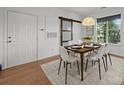 Bright dining area with modern decor, stylish table set and a sliding barn door at 1556 Walnut View Dr, Charlotte, NC 28208