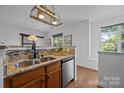 Cozy kitchen features granite counters, stainless appliances and a light-filled window at 1556 Walnut View Dr, Charlotte, NC 28208