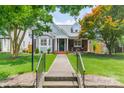 Attractive home with lush lawn and cozy front porch with rocking chairs, creating a welcoming entrance at 2021 Charlotte Dr, Charlotte, NC 28203
