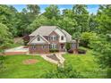 Stunning aerial view of a brick home surrounded by lush greenery and a well-maintained lawn at 2030 Fasana Rd, York, SC 29745