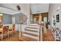 Inviting entryway showcasing hardwood floors, a staircase, and an open view into the living area at 2030 Fasana Rd, York, SC 29745
