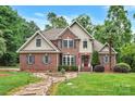 Beautiful brick home featuring a stone pathway, manicured lawn, and a welcoming front entrance at 2030 Fasana Rd, York, SC 29745