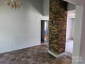 Living room with a brick column and flooring transition at 211 Putnam St, Shelby, NC 28152