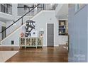 Grand foyer with hardwood floors, a staircase, and stylish decor creating a welcoming atmosphere at 224 Wendover Heights Cir, Charlotte, NC 28211