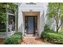 Elegant front door framed by lush greenery and lantern-style lighting creating a welcoming entrance at 224 Wendover Heights Cir, Charlotte, NC 28211