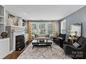 Cozy living room featuring a fireplace, built-in shelves, and comfortable seating at 224 Wendover Heights Cir, Charlotte, NC 28211