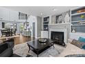 Spacious living room with fireplace and views into the dining room, with stylish decor and comfortable seating at 224 Wendover Heights Cir, Charlotte, NC 28211