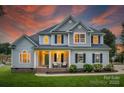 Beautiful two-story home with a welcoming porch and manicured landscaping at 2593 Las Brisas Ln, Denver, NC 28037