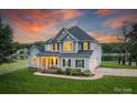 Charming waterfront home with inviting front porch and manicured lawn at 2593 Las Brisas Ln, Denver, NC 28037