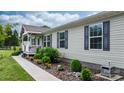 Single-story home with gray siding, black shutters, and a landscaped walkway leading to the covered front porch at 2843 Hopewell Church Rd, Sherrills Ford, NC 28673
