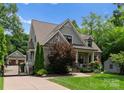 Craftsman-style home with fenced driveway and lush green lawn at 2941 Forest Park Dr, Charlotte, NC 28209