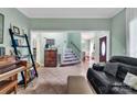 Inviting living space with tile floors leading to a staircase and dining area at 4502 Magnolia Ridge Dr, Waxhaw, NC 28173