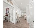 Bright foyer featuring hardwood floors, ornate trim, and an open floor plan leading to the living spaces at 5002 Samoa Ridge Dr, Lancaster, SC 29270
