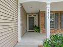 Inviting covered front porch showcasing stone accents, sturdy columns, and a welcoming entry door at 5306 Prosperity View Dr, Charlotte, NC 28269