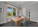 Dining room featuring a rustic wooden table, stylish chairs, and large windows overlooking the landscape at 536 Spring Landing Dr, Rock Hill, SC 29730