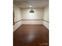 Bright dining room featuring wood-look laminate flooring and a hanging chandelier at 550 Camrose Ne Cir, Concord, NC 28025