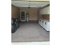 Spacious garage area with ample storage including cabinets and utility sink at 550 Camrose Ne Cir, Concord, NC 28025