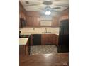 A well-appointed kitchen with tile flooring, wood cabinets, and modern appliances at 550 Camrose Ne Cir, Concord, NC 28025
