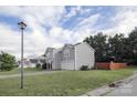 Street view of a two-story house with light gray siding, a garage and a lawn at 585 Gentle Breeze Ln, Rock Hill, SC 29730