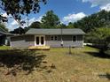 View of the back of the home that features a small back porch with french doors at 801 Calhoun St, Lancaster, SC 29720