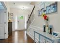 Bright foyer with hardwood floors, elegant lighting, and staircase at 9511 Spurwig Ct, Charlotte, NC 28278