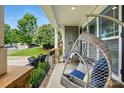 Cozy front porch featuring hanging swing chairs and decorative flower boxes at 9511 Spurwig Ct, Charlotte, NC 28278