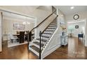 Open staircase with dark wood handrail, leading to the upper level at 9511 Spurwig Ct, Charlotte, NC 28278