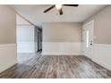 Open-concept living room with gray flooring and neutral walls with white trim and ceiling fan at 1010 Fallston Rd, Shelby, NC 28150