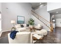 Bright living room featuring hardwood floors, a cozy seating area, and a staircase at 10198 Tintinhull Dr, Fort Mill, SC 29707