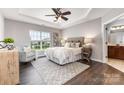 Cozy primary bedroom boasts trey ceilings, and a large window at 10198 Tintinhull Dr, Indian Land, SC 29707