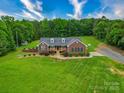 Beautiful front exterior of the home featuring a well-manicured lawn and a cozy front porch at 1060 S Lentz Harness Shop Rd, Mount Pleasant, NC 28124