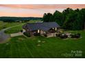 Aerial view of a beautiful home with a large backyard, covered patio, and lush landscaping at 1060 S Lentz Harness Shop Rd, Mount Pleasant, NC 28124